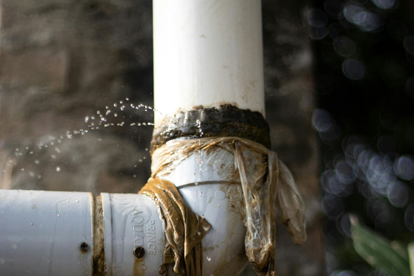 Close-up of a leaking pipe with water dripping — the subject of every leak-detection call